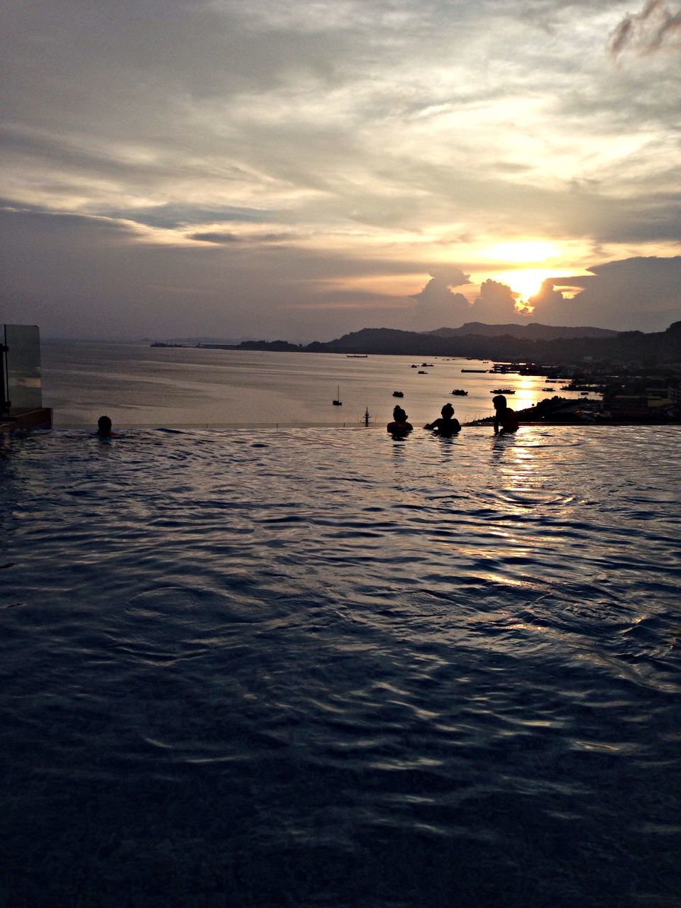 water, sea, sky, silhouette, men, leisure activity, lifestyles, scenics, sunset, tranquility, tranquil scene, beauty in nature, nature, reflection, waterfront, unrecognizable person, rippled