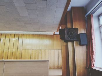 Low angle view of telephone booth against wall