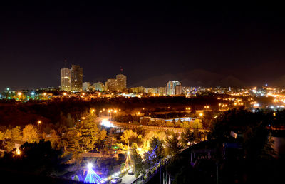 High angle view of illuminated city buildings at night