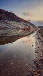 Scenic view of snowcapped mountains against sky during sunset