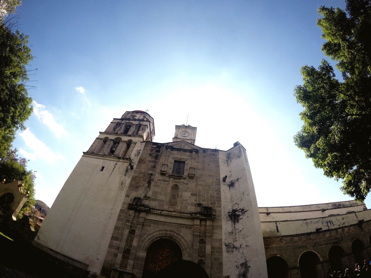 architecture, built structure, low angle view, building exterior, history, place of worship, religion, sky, blue, old, church, tree, spirituality, the past, clear sky, arch, famous place, travel destinations