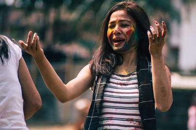 Young woman with powder paint on face during holi