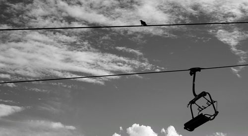 Low angle view of silhouette street light against sky