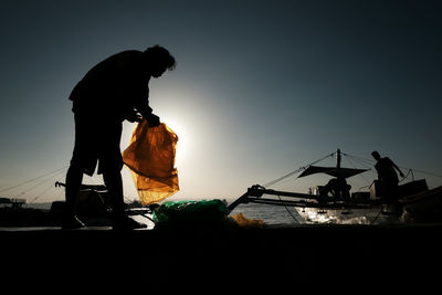 Low angle view of a silhouette man against clear sky