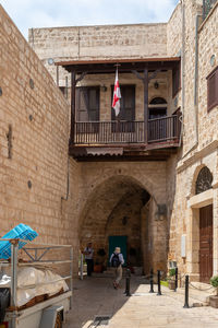 People in historic building in city