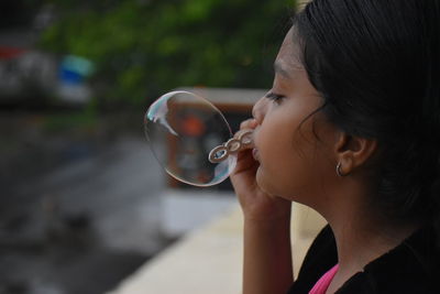 Portrait of a girl blowing bubbles