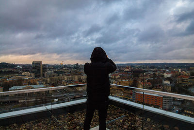 Cityscape against cloudy sky