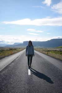 Full length of woman on road against sky