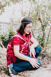 Young woman sitting on field