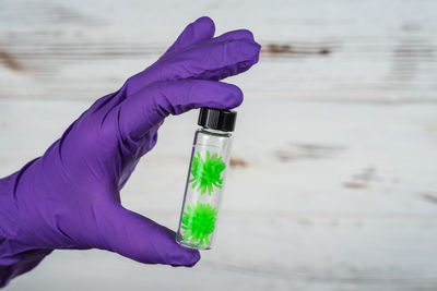 Close-up of hand holding purple water