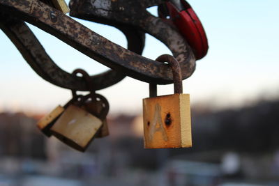 Close-up of padlocks hanging against sky