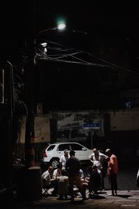 People in illuminated city at night