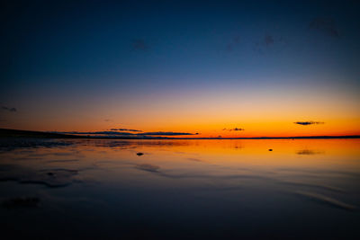 Scenic view of sea against orange sky