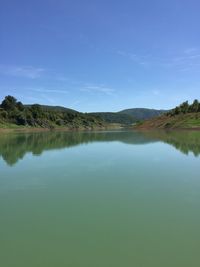 Scenic view of lake against blue sky