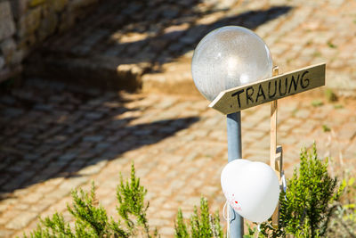 Close-up of sign on pole against blurred background