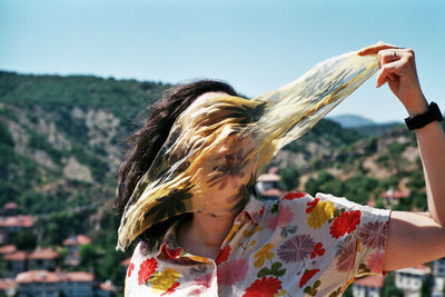 Portrait of woman with arms raised