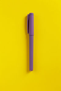 Directly above shot of multi colored pencils on yellow background