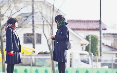 Rear view of people walking in snow