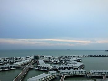 Aerial view of cityscape by sea against sky