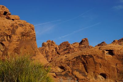 Low angle view of rock formations against sky