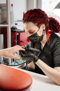 Side view of young woman using mobile phone at home