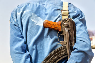 Rear view of man with gun