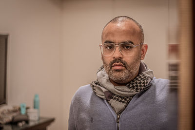 Mature man reflecting on mirror at home