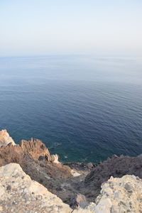 High angle view of rocks in sea against clear sky