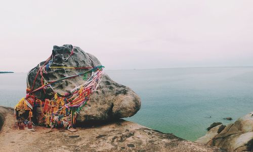 Rocks on shore against sea and sky