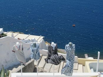 High angle view of chairs by sea against buildings