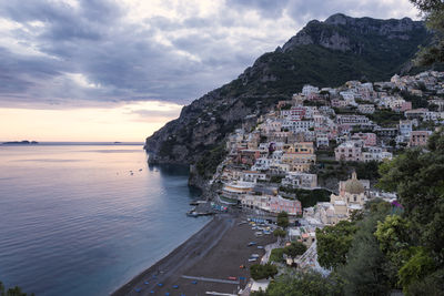 High angle view of townscape by sea against sky