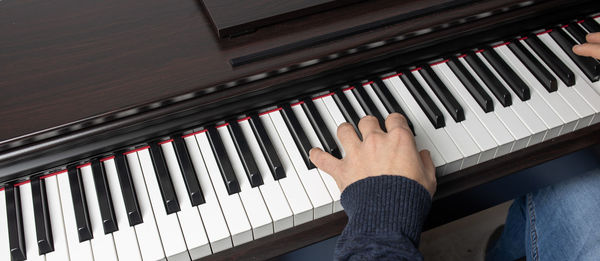 High angle view of man playing piano