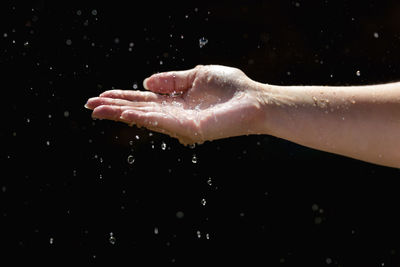 Close-up of hand splashing water