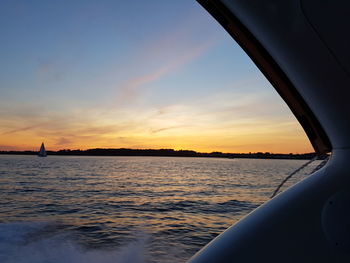 Close-up of sea against sky during sunset
