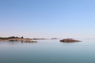 Scenic view of river against clear blue sky