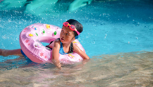 Children frolic at the water park. it is a sunny, perfect day for getting wet and playing hard.