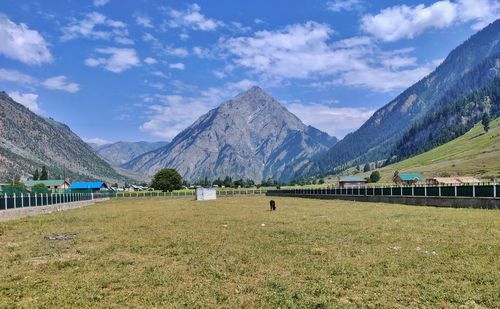 Scenic view of landscape and mountains against sky