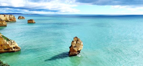 Panoramic view of rock on sea against sky