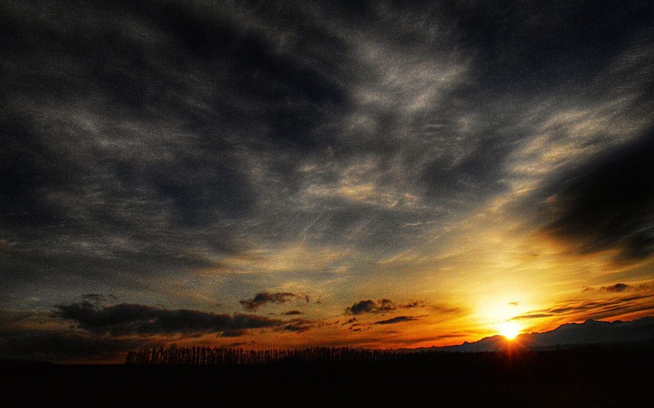 sunset, silhouette, tranquil scene, sky, tranquility, scenics, beauty in nature, landscape, cloud - sky, nature, idyllic, sun, cloudy, dramatic sky, field, cloud, weather, dark, outdoors, orange color