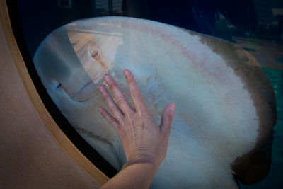 Close-up of hand on glass