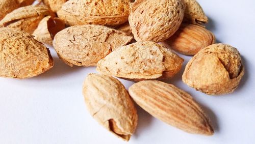 Close-up of almonds against white background