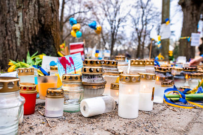 Thousands candles and flowers standing on the street during the war in ukraine