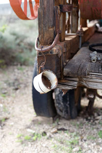 Close-up of rusty metal on wood in field