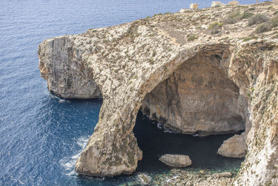 Low angle view of rock formation in sea