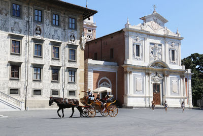 People riding bicycles on roadside