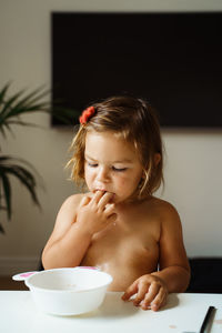 Portrait of cute girl sitting on table