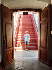 Full length of woman standing in corridor