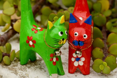 Hand made toys in intense colour yellow blue red green against flat colour background