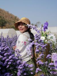 Portrait of smiling girl with purple flowers