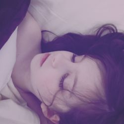 Close-up of girl sleeping on bed